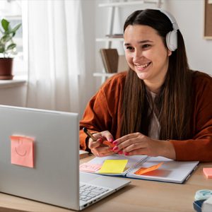 Student reading book in library wearing mask